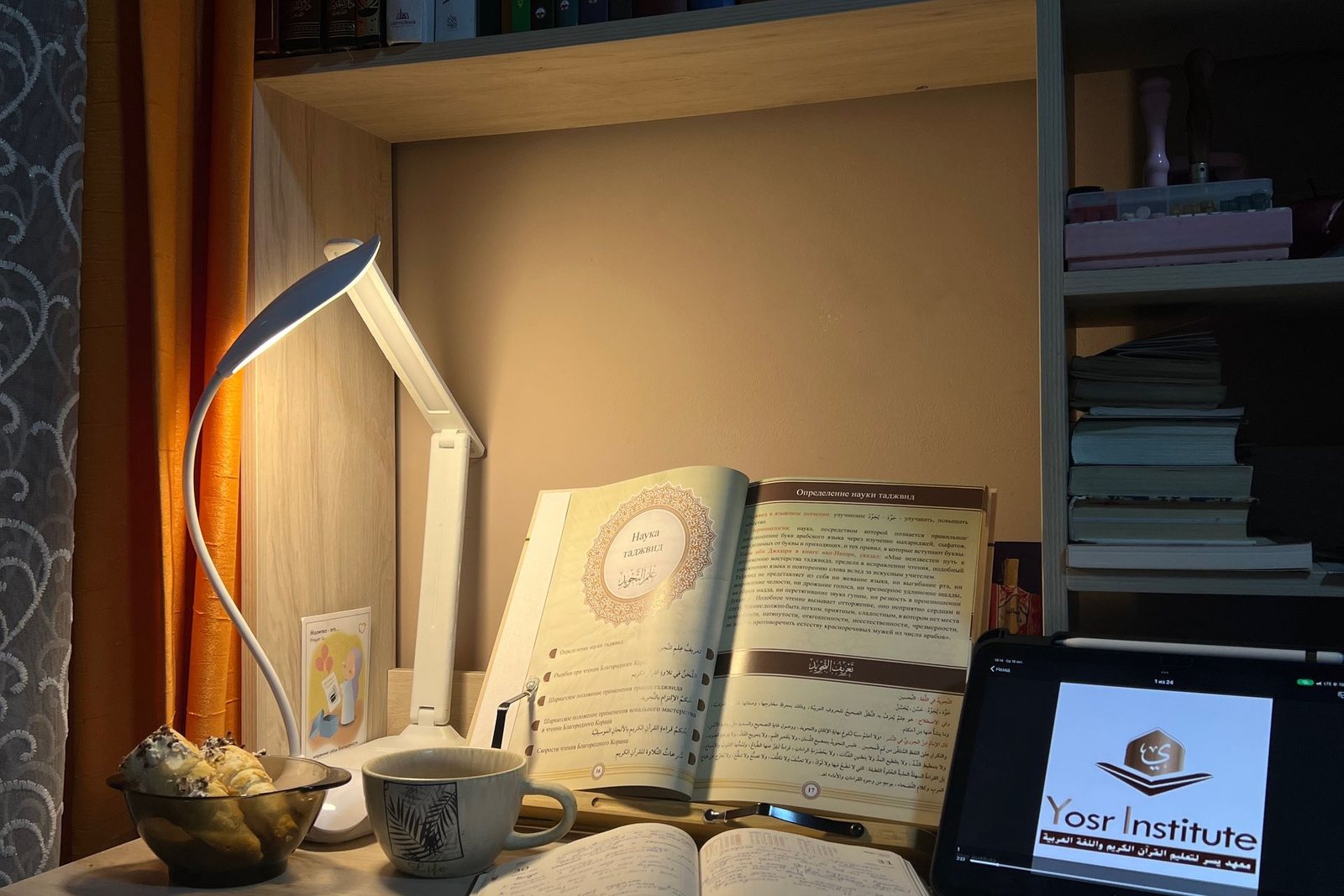 An open book under a desk lamp, representing plain-English commercial real estate definitions.