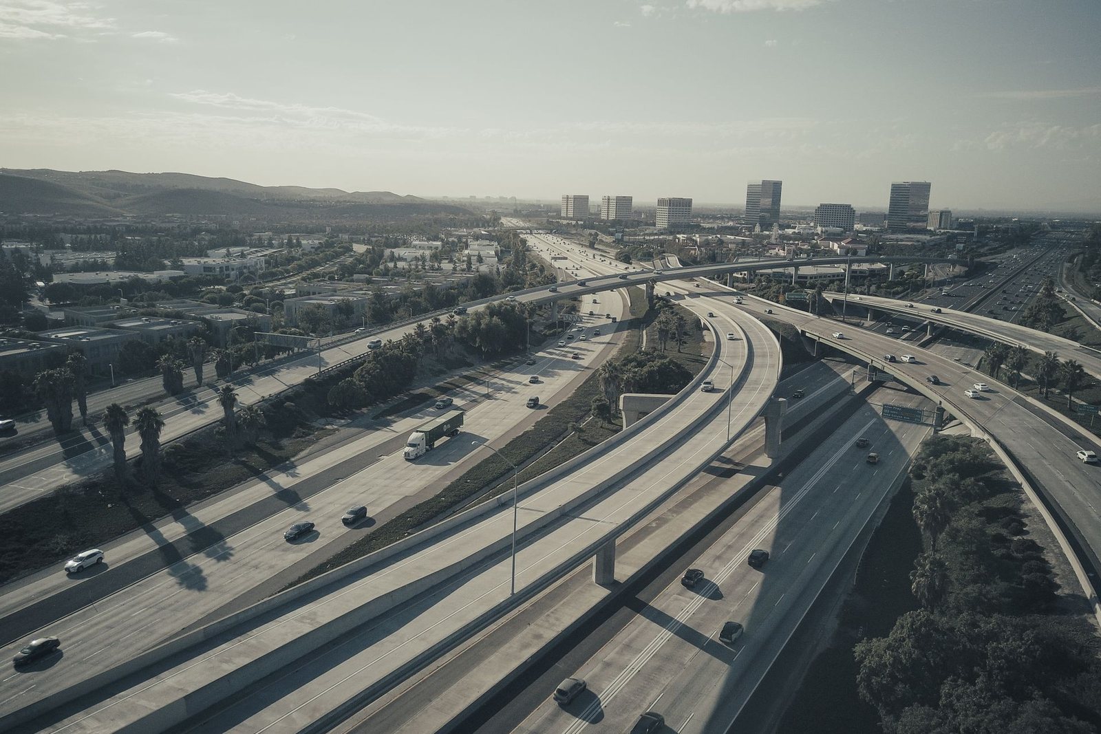 A highway leading toward a distant city skyline.